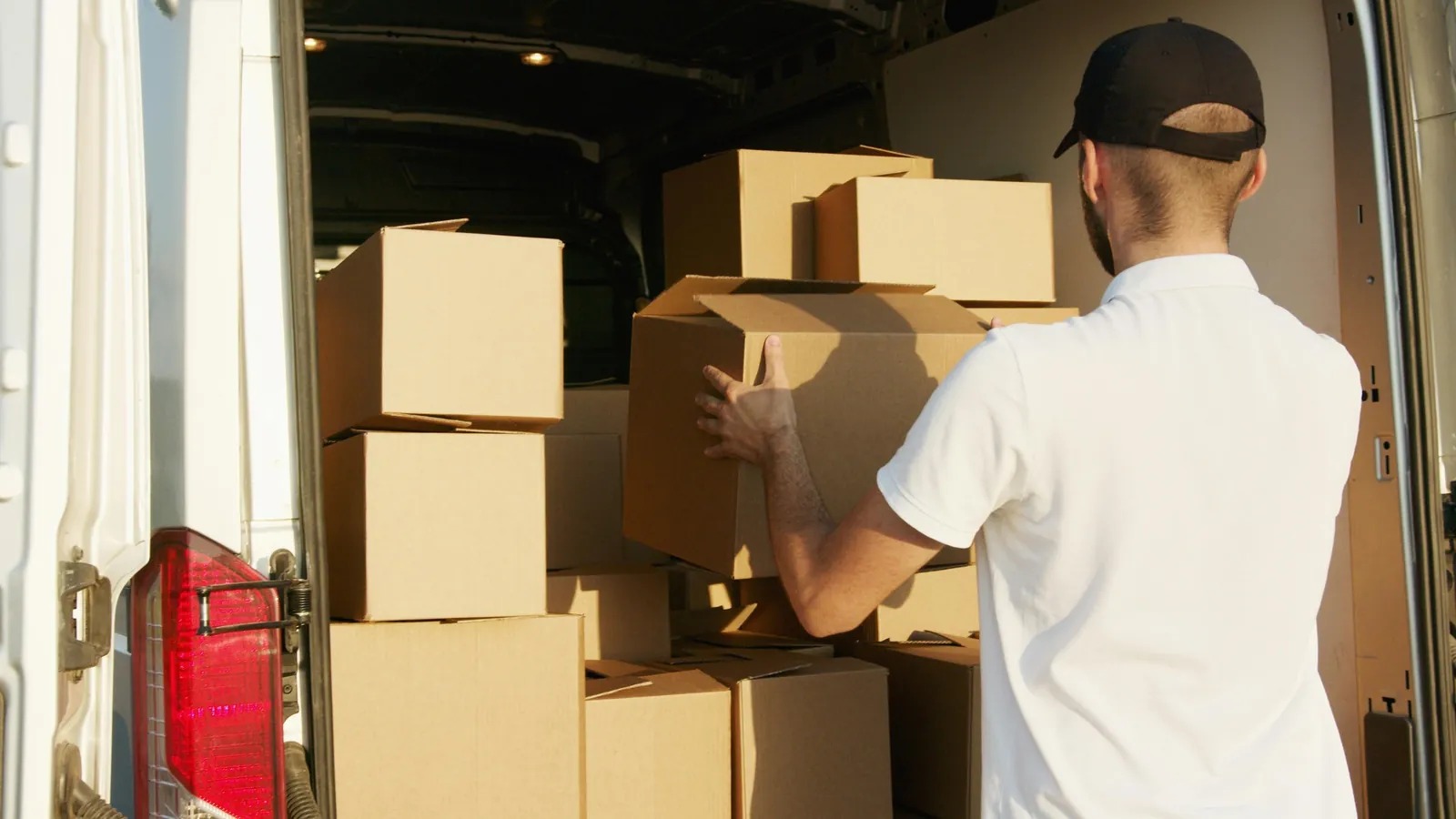 Mover arranging boxes in the back of a van